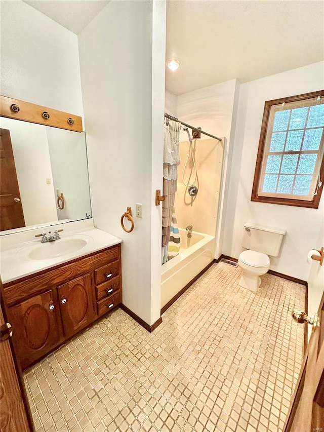 bathroom with baseboards, toilet, vanity, shower / bathtub combination with curtain, and tile patterned flooring