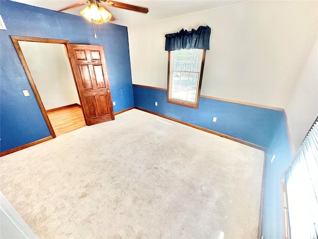 unfurnished bedroom featuring carpet, baseboards, and ceiling fan
