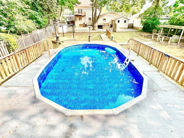 view of pool with a fenced backyard