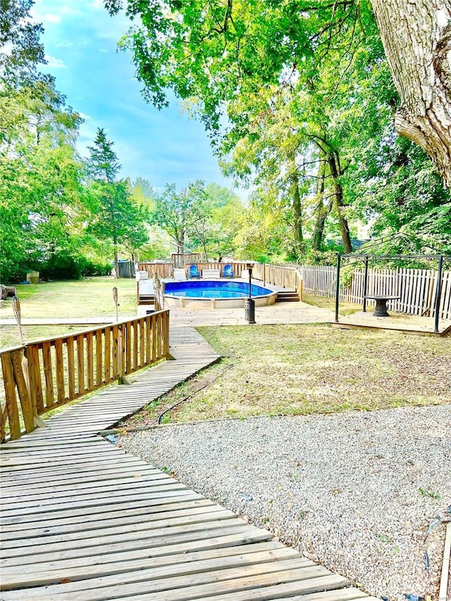 view of yard with a deck and view of scattered trees
