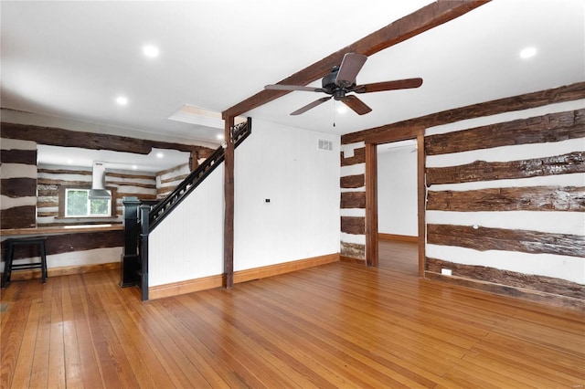1137 Main St, Maeystown, IL 62256 - unfurnished living room with hardwood / wood-style floors, a ceiling fan, baseboards, stairway, and a wood stove