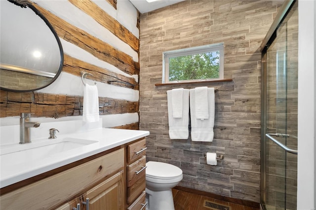 1137 Main St, Maeystown, IL 62256 - bathroom featuring vanity, a stall shower, toilet, and wood finished floors