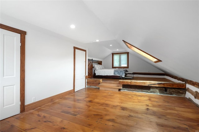 1137 Main St, Maeystown, IL 62256 - unfurnished bedroom with lofted ceiling, wood-type flooring, recessed lighting, baseboards, and a skylight