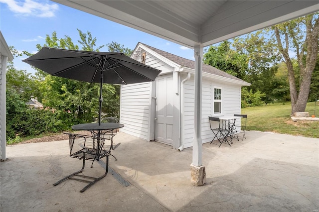 1137 Main St, Maeystown, IL 62256 - view of patio featuring outdoor dining space and an outbuilding