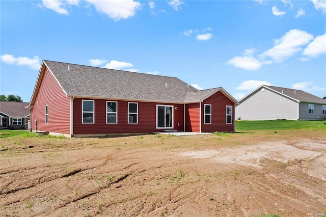 view of front of home featuring a patio and a shingled roof