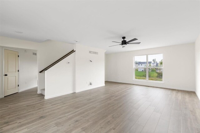 102 Harrow Dr, Ofallon, MO 63385 - unfurnished living room featuring ceiling fan, light wood-type flooring, and baseboards