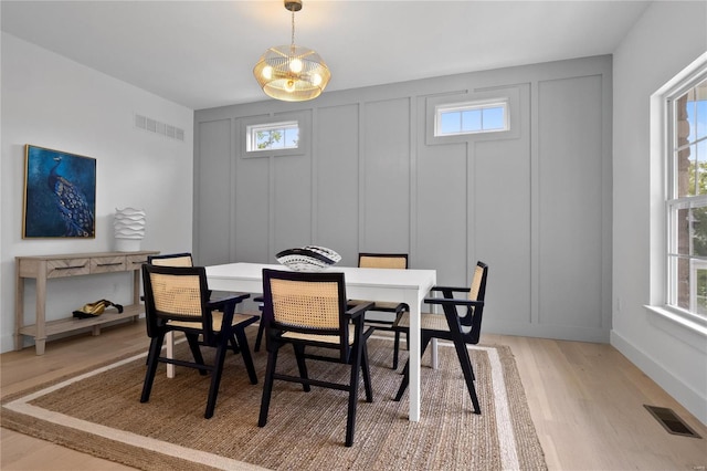 2017 Woodsey Dr, Brentwood, MO 63144 - dining room featuring a decorative wall, light wood-style flooring, plenty of natural light, and baseboards