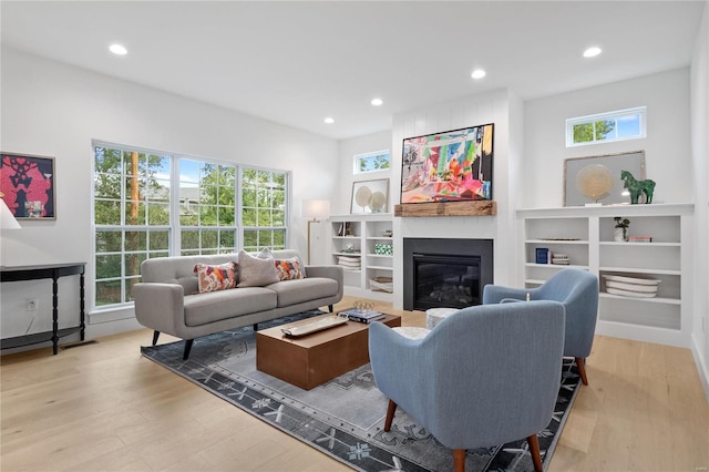 2017 Woodsey Dr, Brentwood, MO 63144 - living area with wood finished floors, a large fireplace, and recessed lighting