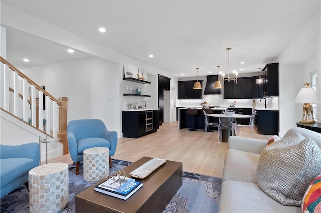 2017 Woodsey Dr, Brentwood, MO 63144 - living room with light wood finished floors, bar, recessed lighting, stairway, and a chandelier
