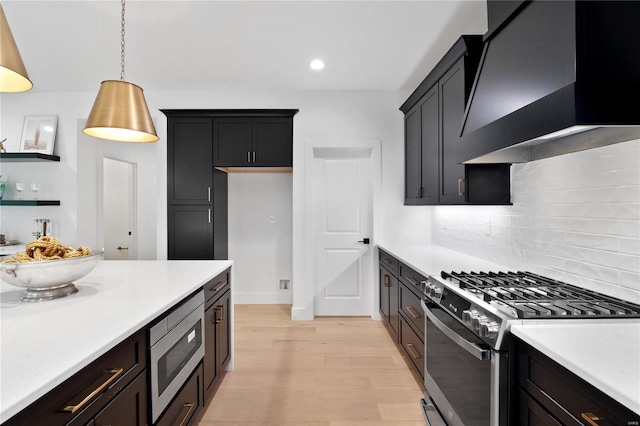 2017 Woodsey Dr, Brentwood, MO 63144 - kitchen featuring appliances with stainless steel finishes, custom exhaust hood, light countertops, light wood finished floors, and open shelves