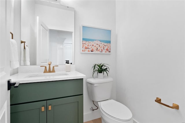 2017 Woodsey Dr, Brentwood, MO 63144 - bathroom with toilet, vanity, baseboards, and wood finished floors