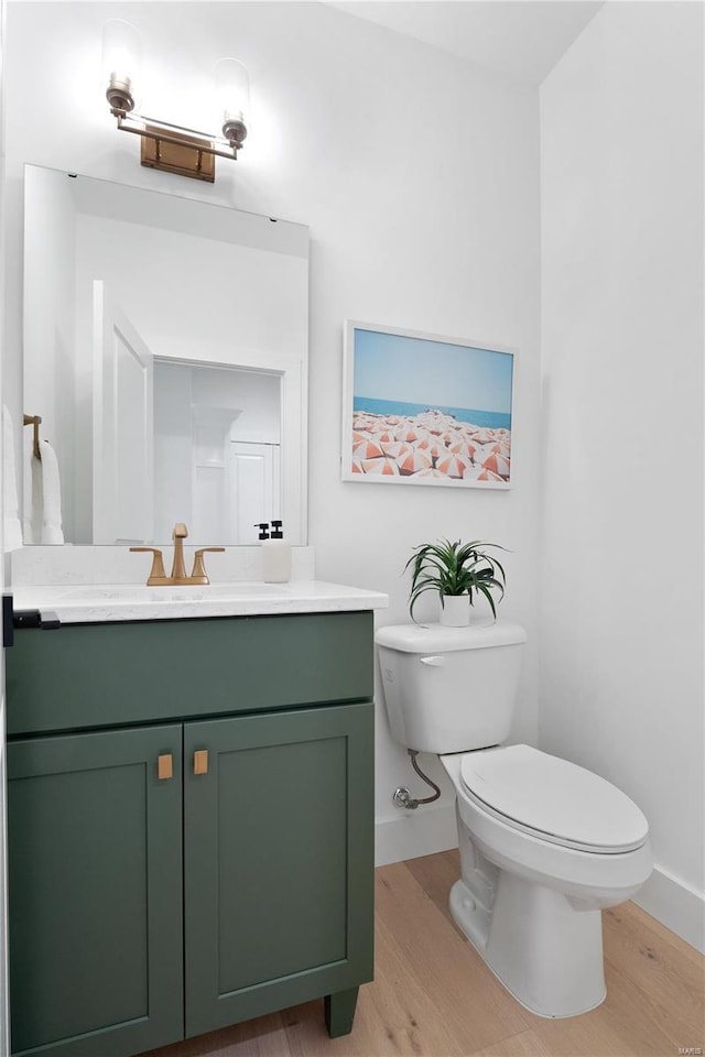 2017 Woodsey Dr, Brentwood, MO 63144 - half bathroom featuring wood finished floors, baseboards, and toilet