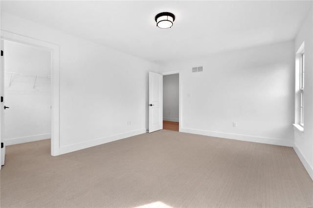 2017 Woodsey Dr, Brentwood, MO 63144 - unfurnished bedroom featuring carpet floors, a walk in closet, a closet, and baseboards