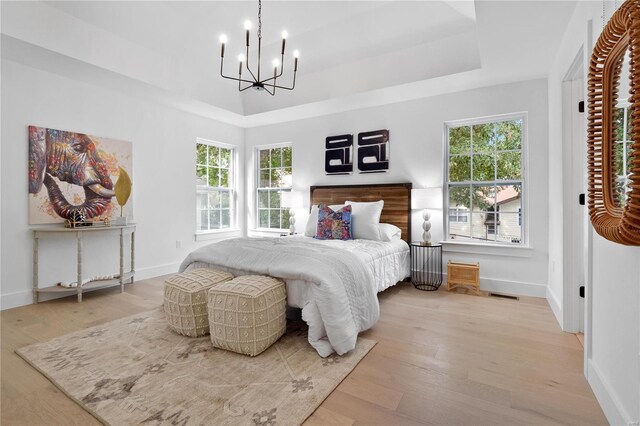 2017 Woodsey Dr, Brentwood, MO 63144 - bedroom featuring a chandelier, multiple windows, and wood finished floors