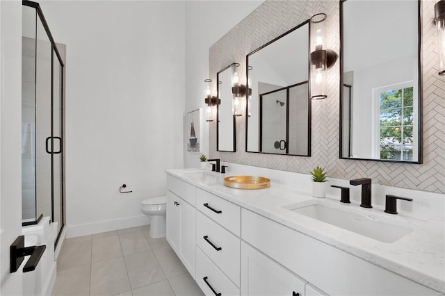 2017 Woodsey Dr, Brentwood, MO 63144 - full bathroom with a shower stall, tile patterned flooring, toilet, double vanity, and baseboards