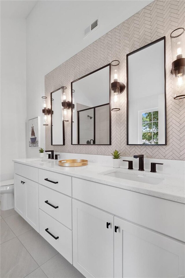 2017 Woodsey Dr, Brentwood, MO 63144 - bathroom with a stall shower, tile patterned flooring, double vanity, and toilet