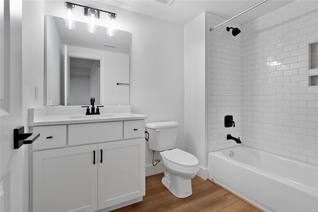 2017 Woodsey Dr, Brentwood, MO 63144 - full bathroom with wood finished floors, toilet, vanity, and tub / shower combination