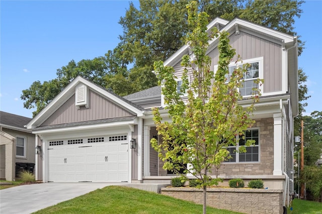 2017 Woodsey Dr, Brentwood, MO 63144 - view of front facade with stone siding, driveway, an attached garage, and board and batten siding