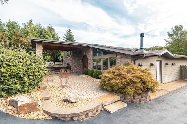 10010 Edmondson Hills Dr, Rolla, MO 65401 - view of front facade with stone siding and a patio