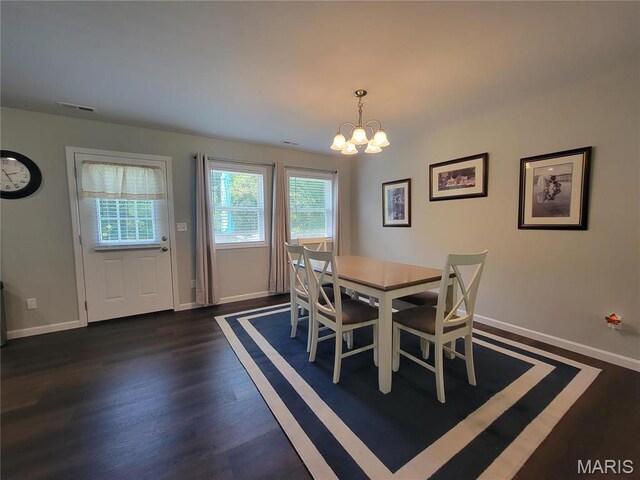 301 S Sloan St, Lebanon, MO 65536 - dining space featuring a chandelier, baseboards, and dark wood-style flooring