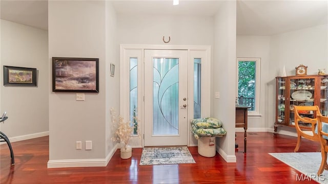 entryway with wood finished floors and baseboards