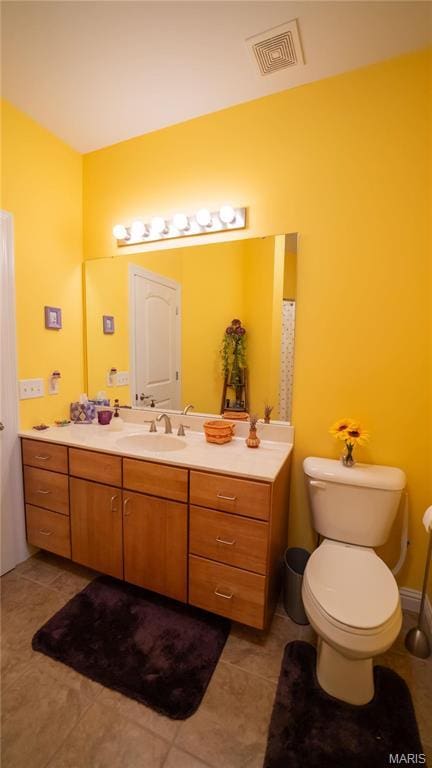 bathroom with tile patterned floors, vanity, and toilet