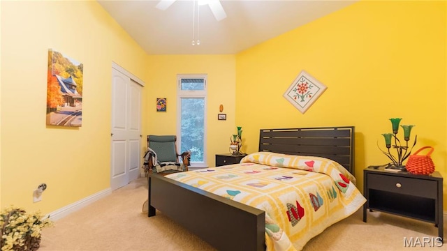 carpeted bedroom featuring baseboards and ceiling fan