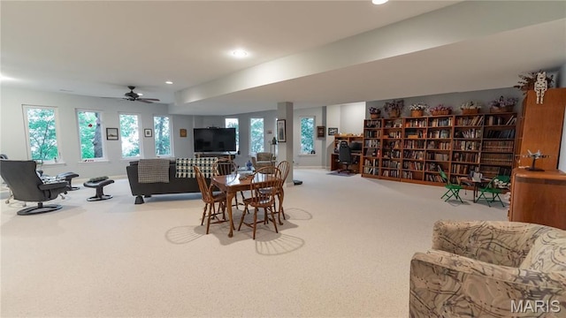carpeted living area with recessed lighting and a ceiling fan