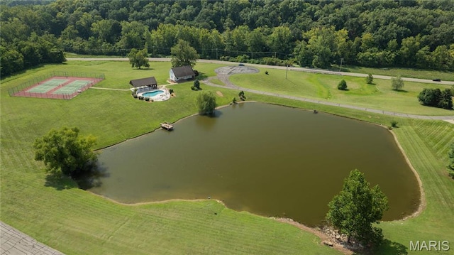 view of rural area with a large body of water and a heavily wooded area