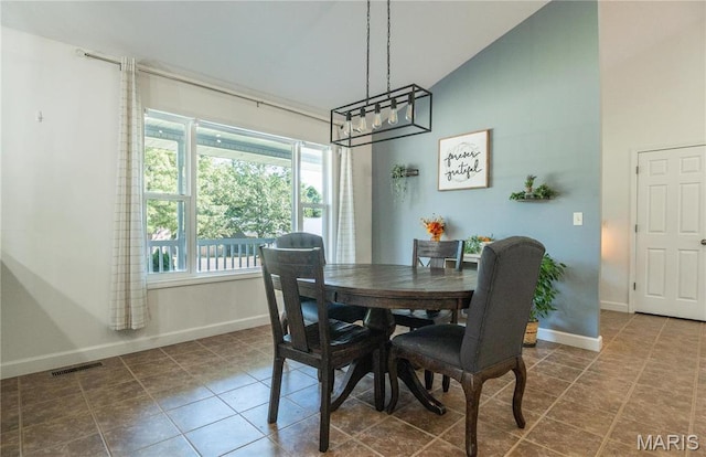 382 Christina Ln, Poplar Bluff, MO 63901 - dining area featuring a chandelier, dark tile patterned floors, and high vaulted ceiling
