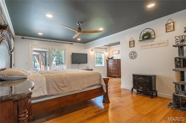 382 Christina Ln, Poplar Bluff, MO 63901 - bedroom featuring a wood stove, access to exterior, ornamental molding, recessed lighting, and light wood finished floors