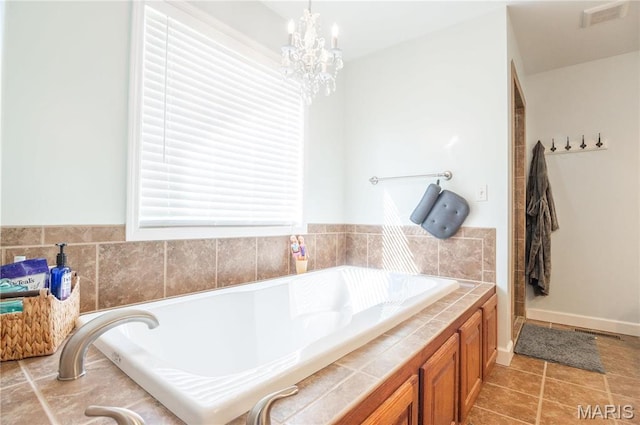 382 Christina Ln, Poplar Bluff, MO 63901 - bathroom featuring a bath, a chandelier, and tile patterned flooring