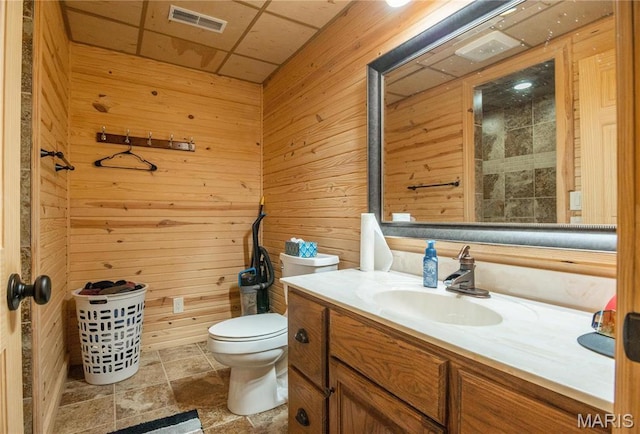 382 Christina Ln, Poplar Bluff, MO 63901 - bathroom featuring vanity, wood walls, and stone finish flooring