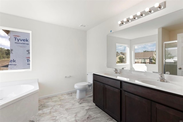 full bath with healthy amount of natural light, marble look tile flooring, a garden tub, and double vanity