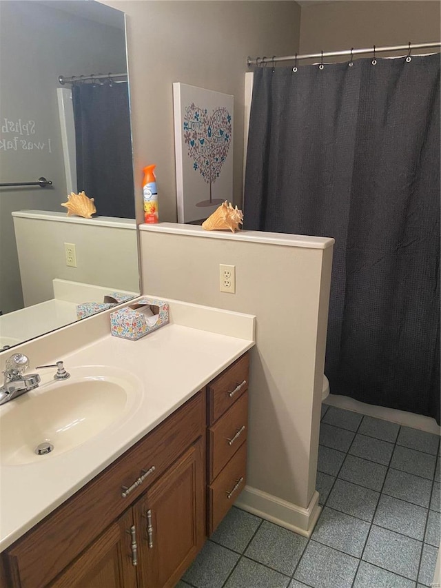 full bathroom with tile patterned flooring, vanity, and toilet