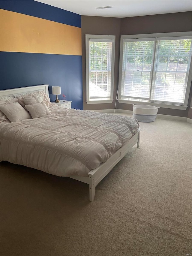carpeted bedroom with baseboards
