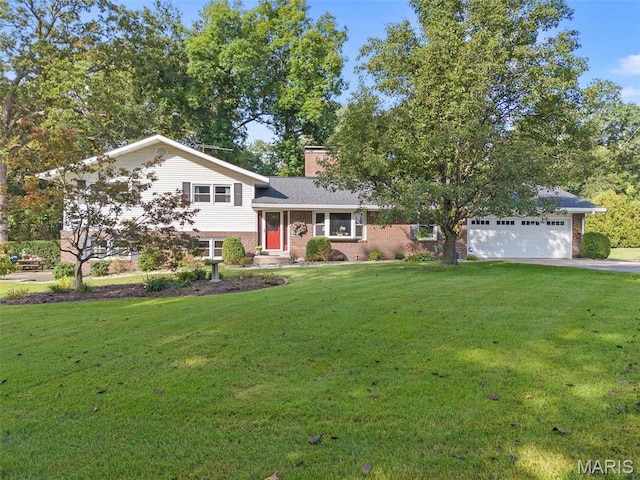 split level home featuring brick siding, a front lawn, a garage, and a chimney