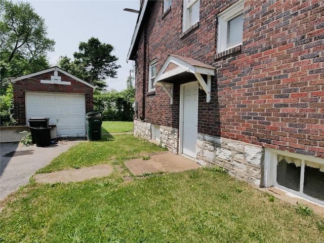 7210 Normandy Pl, Saint Louis, MO 63121 - view of side of home featuring brick siding, a detached garage, an outdoor structure, and a lawn