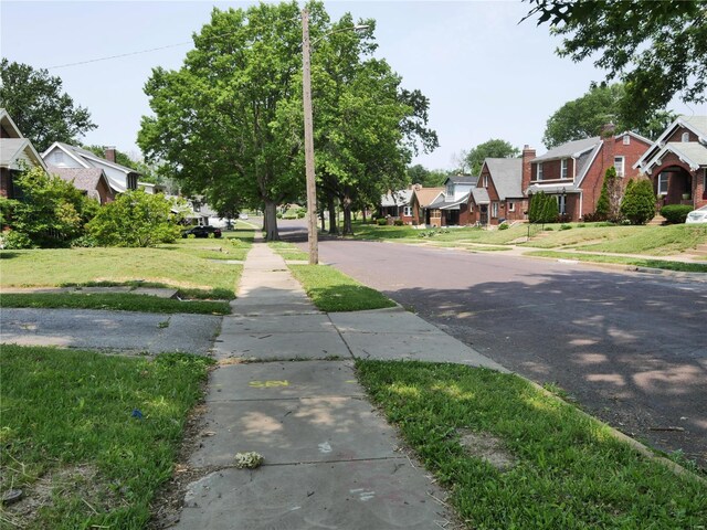 7210 Normandy Pl, Saint Louis, MO 63121 - view of asphalt road featuring a residential view and sidewalks