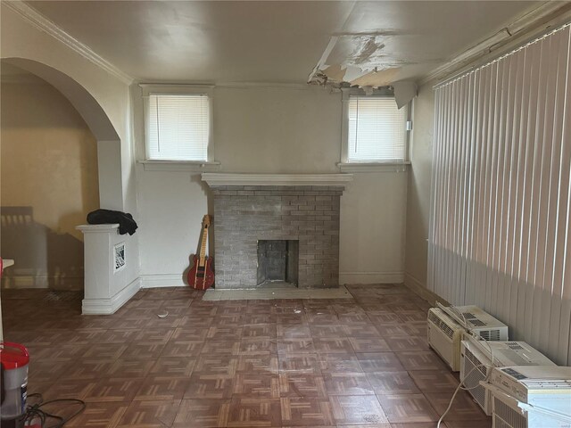 7210 Normandy Pl, Saint Louis, MO 63121 - unfurnished living room with a brick fireplace, arched walkways, ornamental molding, and baseboards