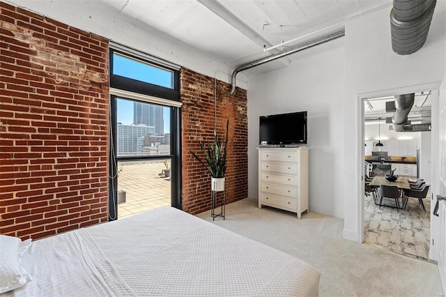 bedroom with light colored carpet and brick wall