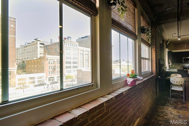 view of side of property with a sink and a balcony