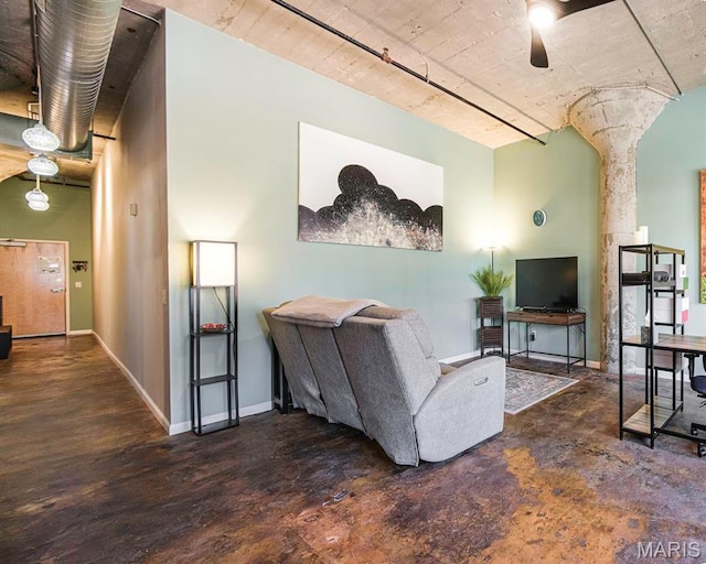living room featuring ceiling fan and baseboards