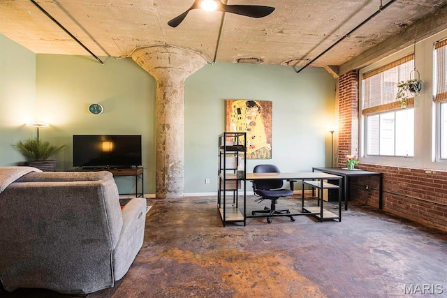 home office with concrete flooring, brick wall, and ceiling fan