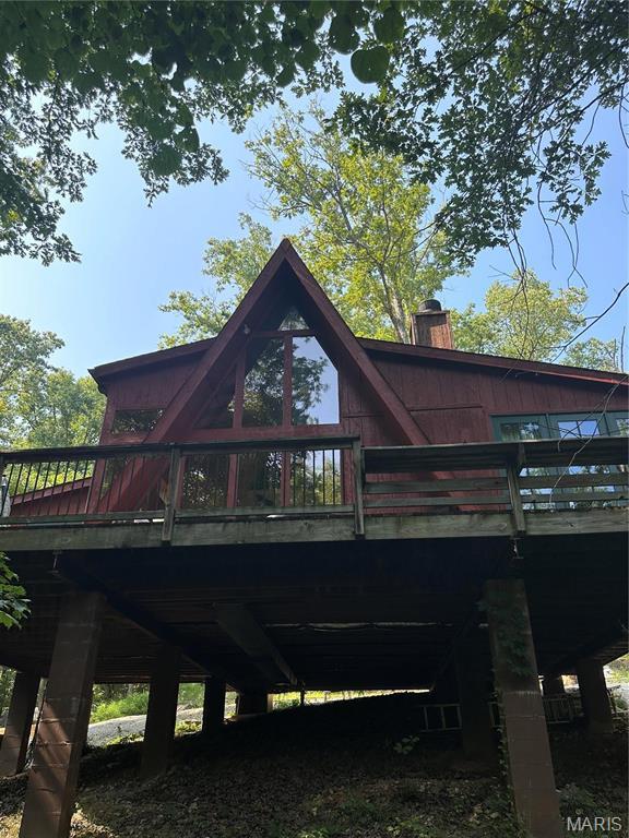 2359 Kitzbuhl Way S, Innsbrook, MO 63390 - rear view of house featuring a deck and a chimney
