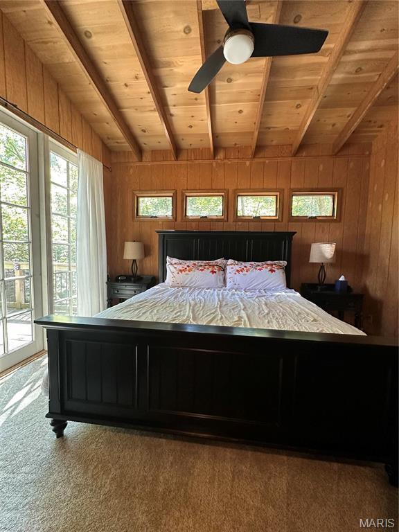 2359 Kitzbuhl Way S, Innsbrook, MO 63390 - bedroom with wood ceiling with exposed beams, access to exterior, wooden walls, carpet flooring, and a ceiling fan