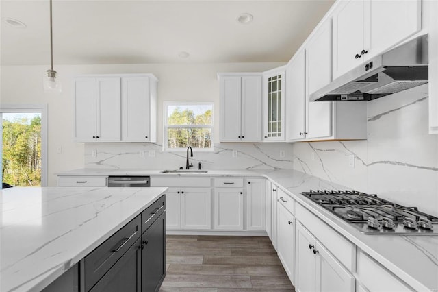 2438 Chukka Dr, Eureka, MO 63025 - kitchen with under cabinet range hood, stainless steel appliances, a sink, white cabinets, and recessed lighting