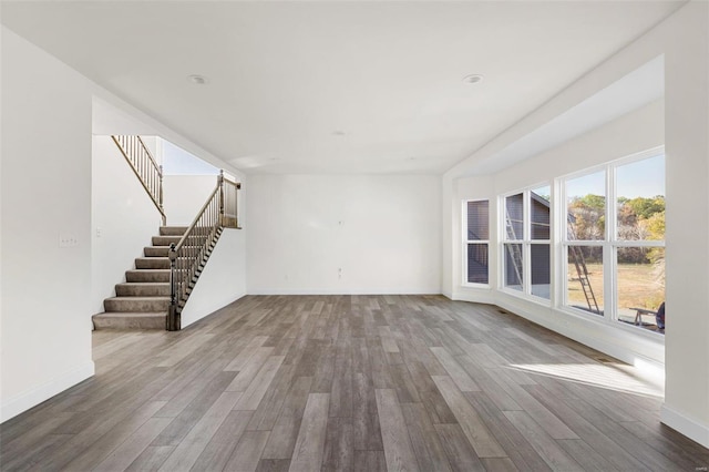 2438 Chukka Dr, Eureka, MO 63025 - unfurnished living room with wood finished floors, stairs, and baseboards