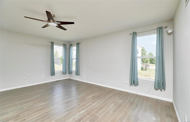120 Kelcross, Wentzville, MO 63385 - spare room with wood finished floors, healthy amount of natural light, ceiling fan, and baseboards