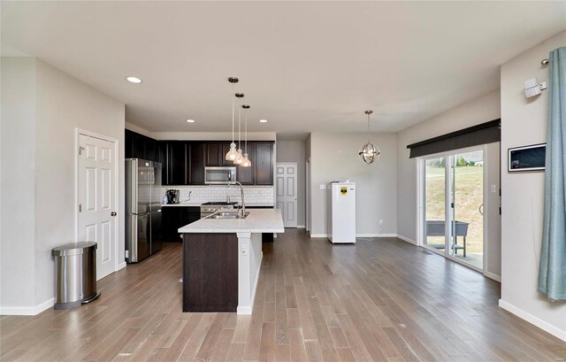 120 Kelcross, Wentzville, MO 63385 - kitchen with stainless steel appliances, light countertops, recessed lighting, baseboards, and wood finished floors